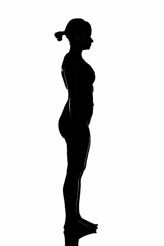 Side view of a woman standing with focus.