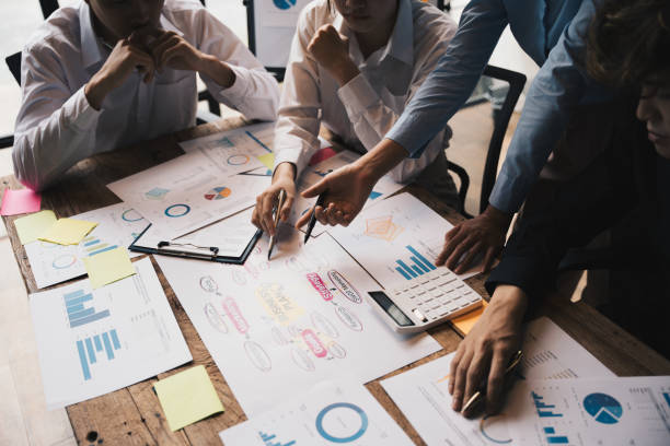 istock Close-up of businesspeople hands pointing a business plan sheet data,discussing, analyzing and brainstorming. 1433854250