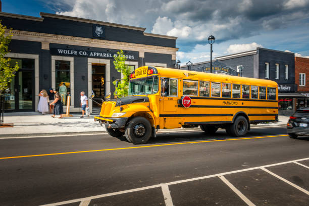 schoolbus at mainstreet in Huntsville in Canada Huntsville, Canada - August 17, 2022: Schoolbus at the mainstreet in Huntsville in Canada. Lots of shops and restaurants along the street. huntsville ontario stock pictures, royalty-free photos & images