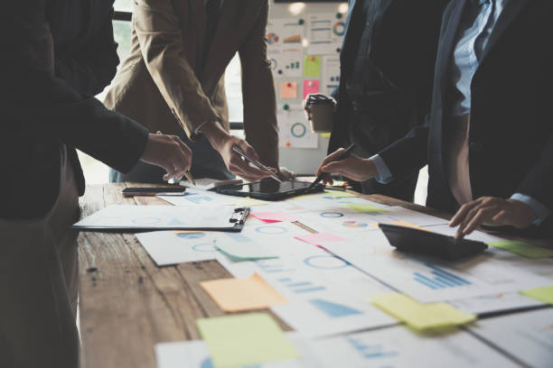 istock Team Business people are analyzing and brainstorming, using calculator, hands pointing financial data on a sheet, Team work process concept. 1433854748