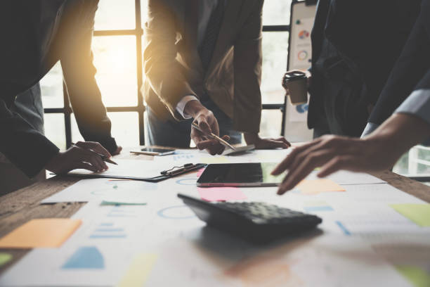 istock Team Business people are analyzing and brainstorming, using calculator, hands pointing financial data on a sheet, Team work process concept. 1433855798