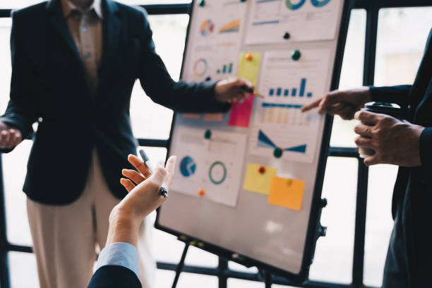 istock business people group Meeting Presentation for Monthly, budget, Loan Comparison, Meeting Discussion Talking Sharing Ideas Concept 1433856492