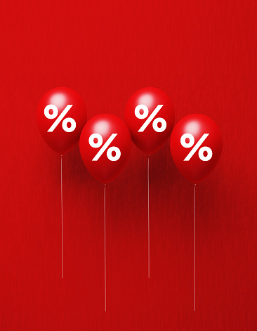 Percentage sign written red balloons on red background. Vertical composition with copy space, Great use for sale and shopping concepts.