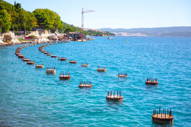 Unfinished bridge columns in the water . Concrete columns with rebar in the sea