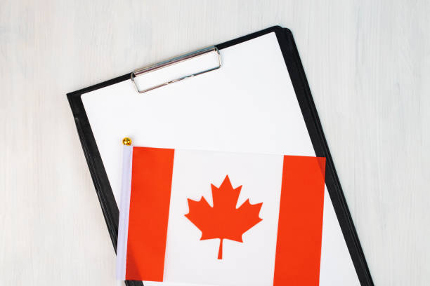 istock Canadian document, mockup for text on clipboard, white sheet of paper in a folder for notes with Canadian flag 1433859667