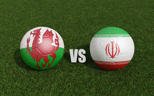 Footballs in flags colors on grass . Wales with Iran. Football championship. 3d rendering