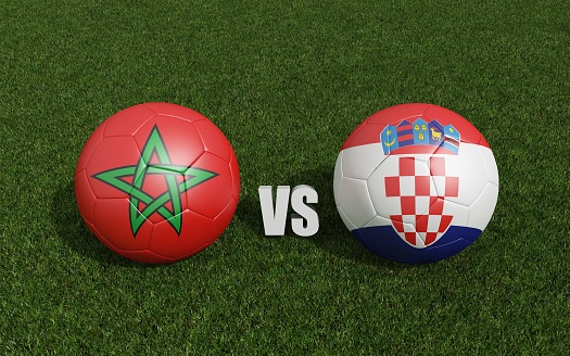 Footballs in flags colors on grass .Morocco with Croatia. World Cup football championship 2022 .3d rendering