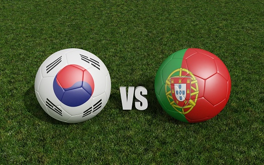 Footballs in flags colors on grass . South Korea with Portugal. World Cup football championship 2022 .3d rendering