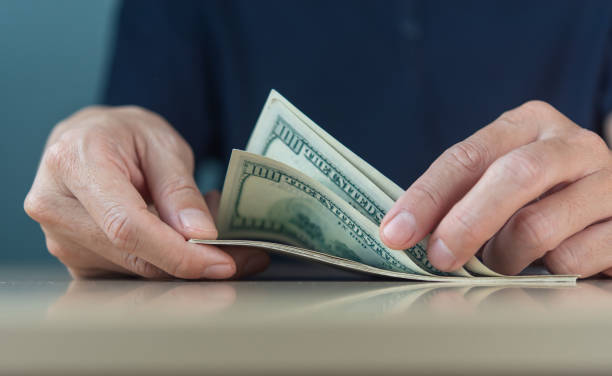 istock Dollar bills were manually counted by businessmen conducting online transactions. 1433864993