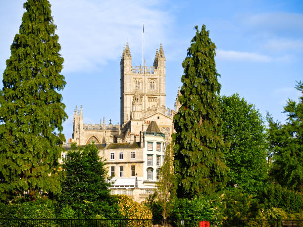 istock Bath Abbey between tall green trees in urban landscape 1433868647