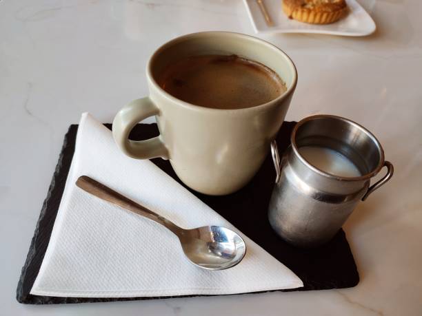Serving coffee with milk at glasgow scotland england uk