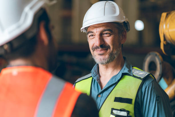 istock industrial factory with men at work concept, professional engineer foreman inspector talking in business occupation job teamwork with team, construction manager working in manufacturing technology job 1433873268