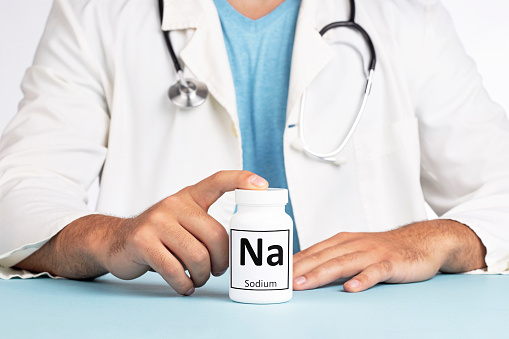 Male doctor and bottle with Na, Sodium