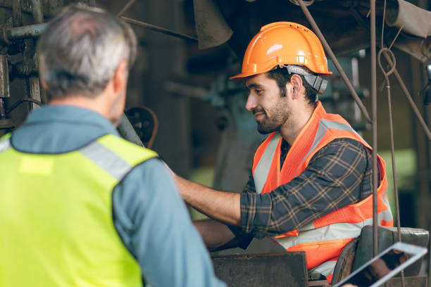 istock industrial factory with men at work concept, professional engineer foreman inspector talking in business occupation job teamwork with team, construction manager working in manufacturing technology job 1433876394