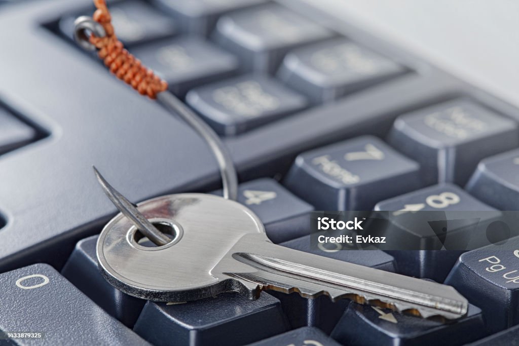 phishing, hacking personal data and money , key and hook on computer keyboard. White Collar Crime Stock Photo