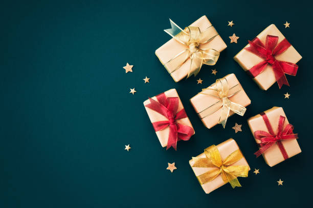 istock Golden Christmas gift or present boxes and star confetti on blue background top view. Flat lay. 1433880796