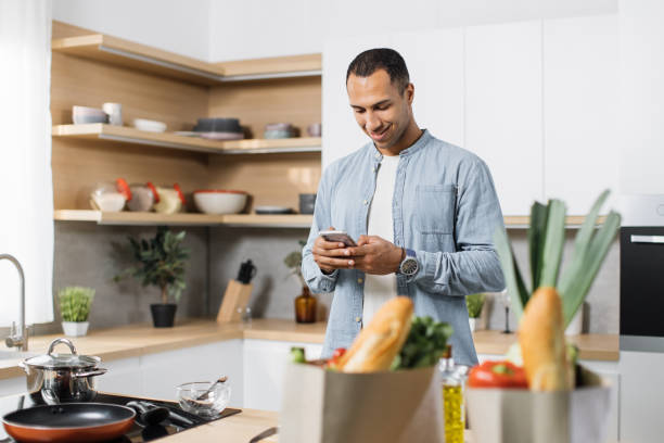 istock Attractive arab man preparing romantic dinner on home kitchen. 1433882722