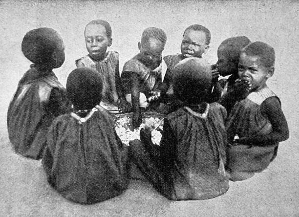 istock Children from Cameroon sitting in a circle eating with hands from a pot 1433887389