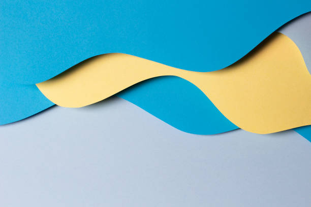 istock Abstract colored paper texture background. Minimal paper cut composition with layers of geometric shapes and lines in yellow and light blue colors. Top view 1433889355