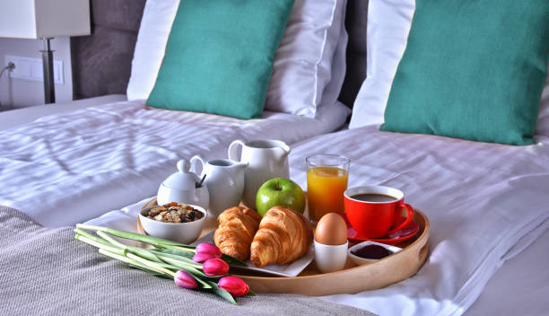 istock Breakfast on tray in bed in hotel room 1433891490