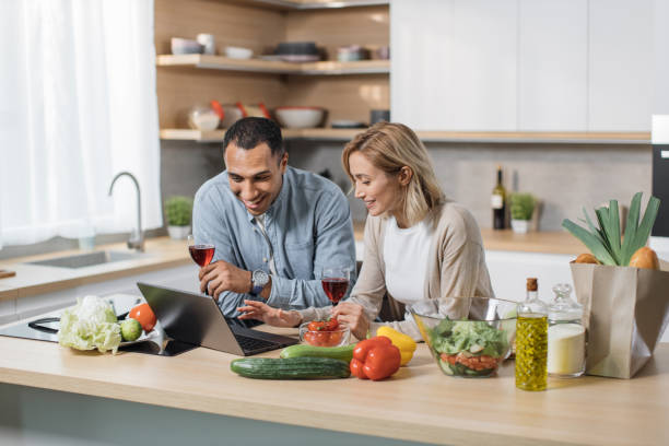 istock Young multiracial couple communicating with kids or relatives, having video chat on laptop computer 1433894404
