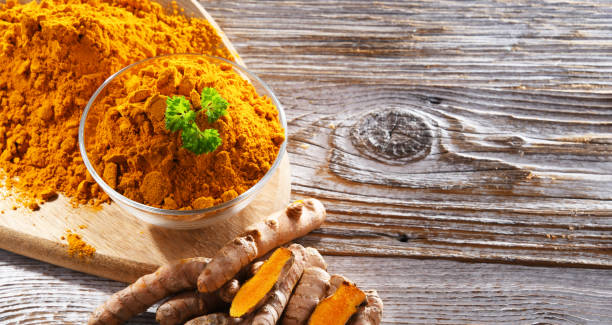 istock Composition with a bowl of ground turmeric and its fresh rhizome 1433894456