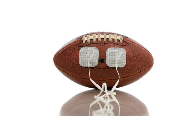 American football on turf with stacks of American dollars. Sports betting and gambling theme