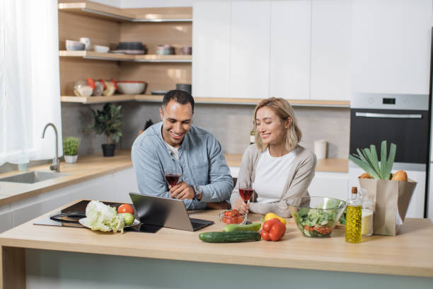 istock Young multiracial couple communicating with kids or relatives, having video chat on laptop computer 1433895210