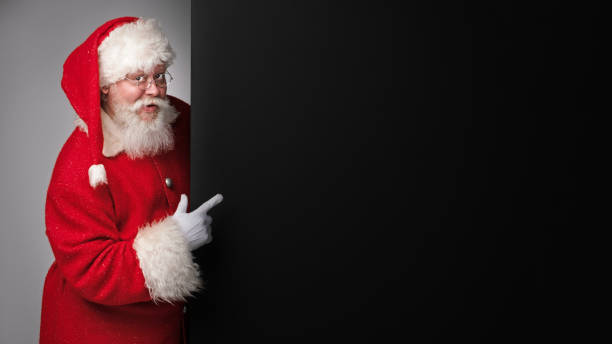 istock Santa Claus pointing black billboard 1433896038