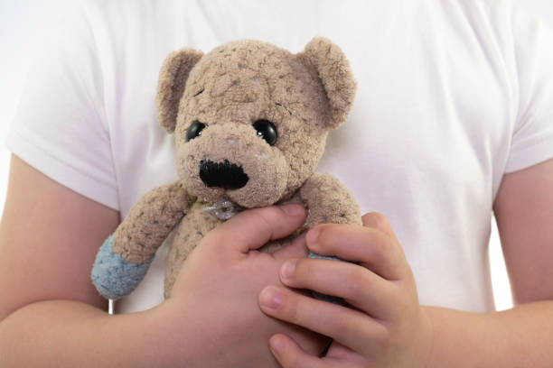 istock Girl holding a teddy bear 1433901777