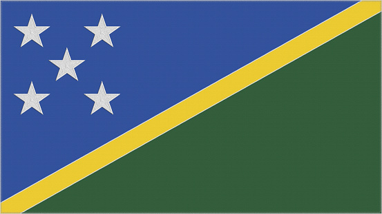 Solomon Islands embroidery flag. Emblem stitched fabric. Embroidered coat of arms. Country symbol textile background.