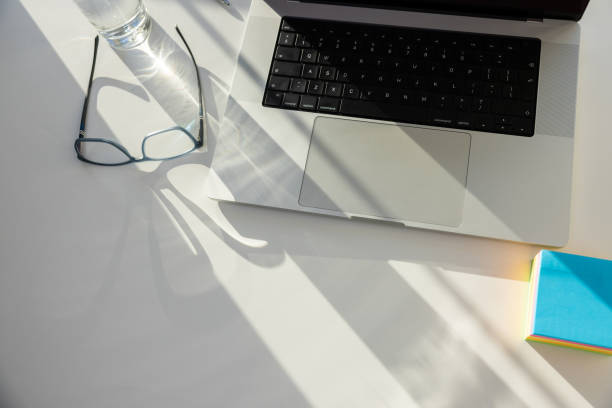 istock Laptop, eyeglasses, drinking glass, and sticky notes on the desk 1433908030