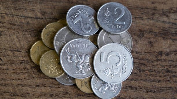 Various old Lithuanian coins isolated on wooden background