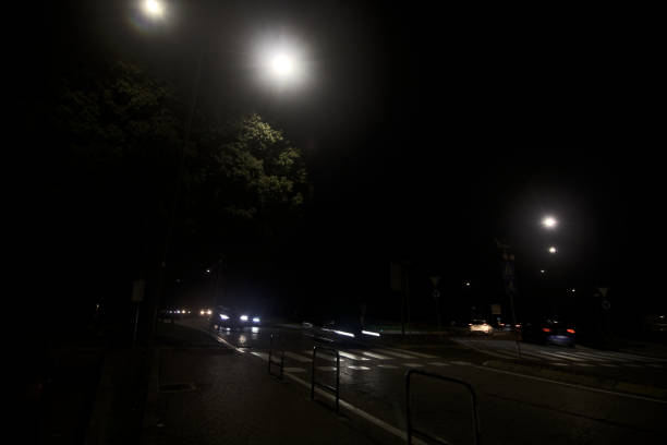 istock Edge of a road with a tree at night 1433908147