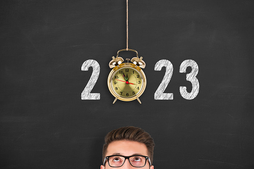 New Year Concepts 2023 Countdown Clock Over Human Head on Chalkboard Background