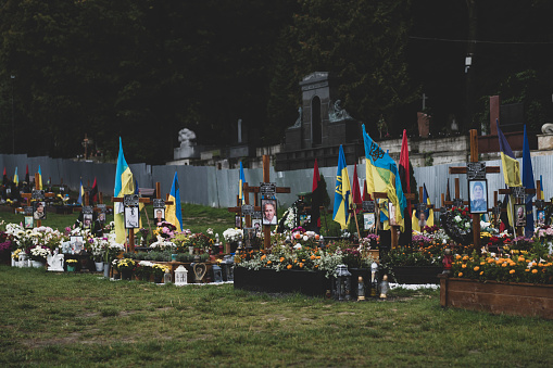 Lviv, Ukraine - September 15, 2022: Flowers, photos, and flags adorn a cemetery where Ukrainian soldiers killed during the 2022 Russian invasion are buried in Lviv.