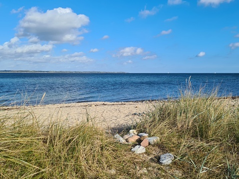 Sea, dune grass, beach, the last sailing boats, clouds - a walk on a Sunday in autumn near Aschau in Eckernförde Bay