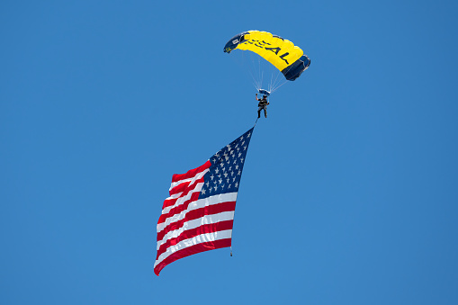 Seal Paratrooper with parachute open and American flag attached and fully open. Photo taken in non ticket area Miramar Airbase in San Diego California USA on September 23, 2022.