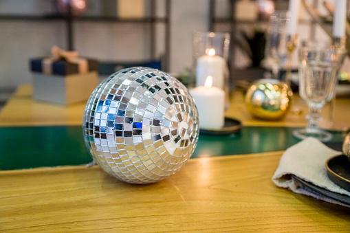 close up mirror ball or Christmas ball to decorative for Christmas festival with bokeh golden tone background. Have some space for write wording