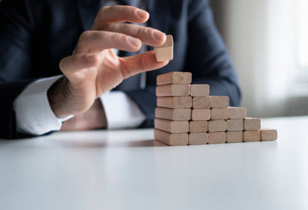 istock Businessman Stop Domino Effect. Risk Management and Insurance Concept 1433916706
