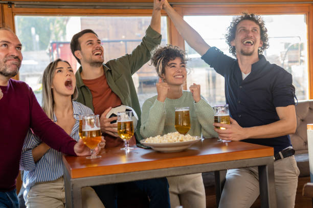 istock People watching soccer game in pub cheering 1433921359