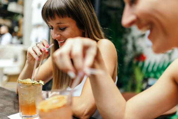 istock Two young women enjoying together while drinking cocktails 1433921892