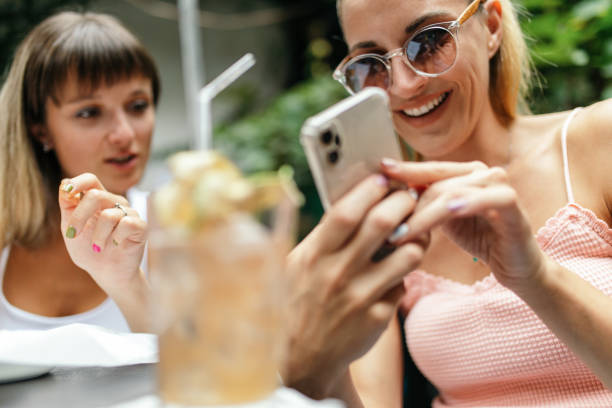 istock Two young women enjoying together while drinking cocktails 1433922252