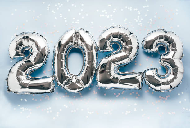 istock 2023 New Year Celebration - silber balloon numbers on blue with confetti 1433922321