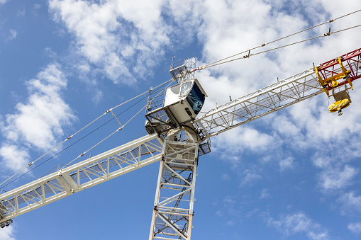 Low ale view of Tower crane at construction in city, sky background with copy space, full frame horizontal composition