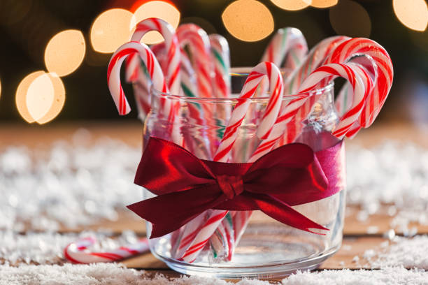 Candy Canes Candy canes in front of Christmas tree Candy Cane stock pictures, royalty-free photos & images