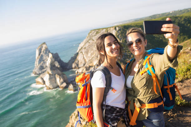 istock Happy female backpackers taking selfie with phone 1433925781