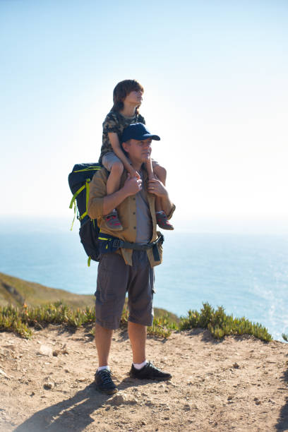 istock Portrait of happy backpacker standing with son 1433925817