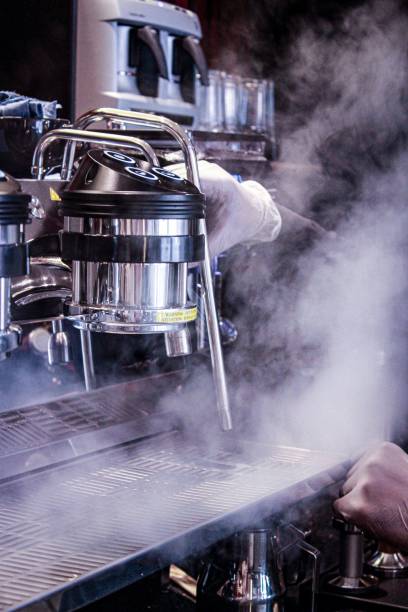 istock Vertical shot of a barista working with a steaming coffee machine 1433934594