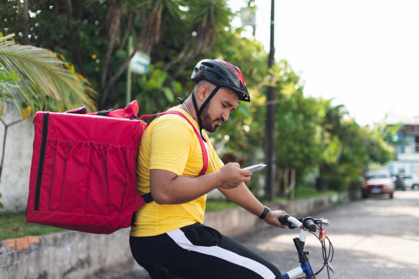 istock Portrait of a delivery man on bicycle with backpack 1433936028